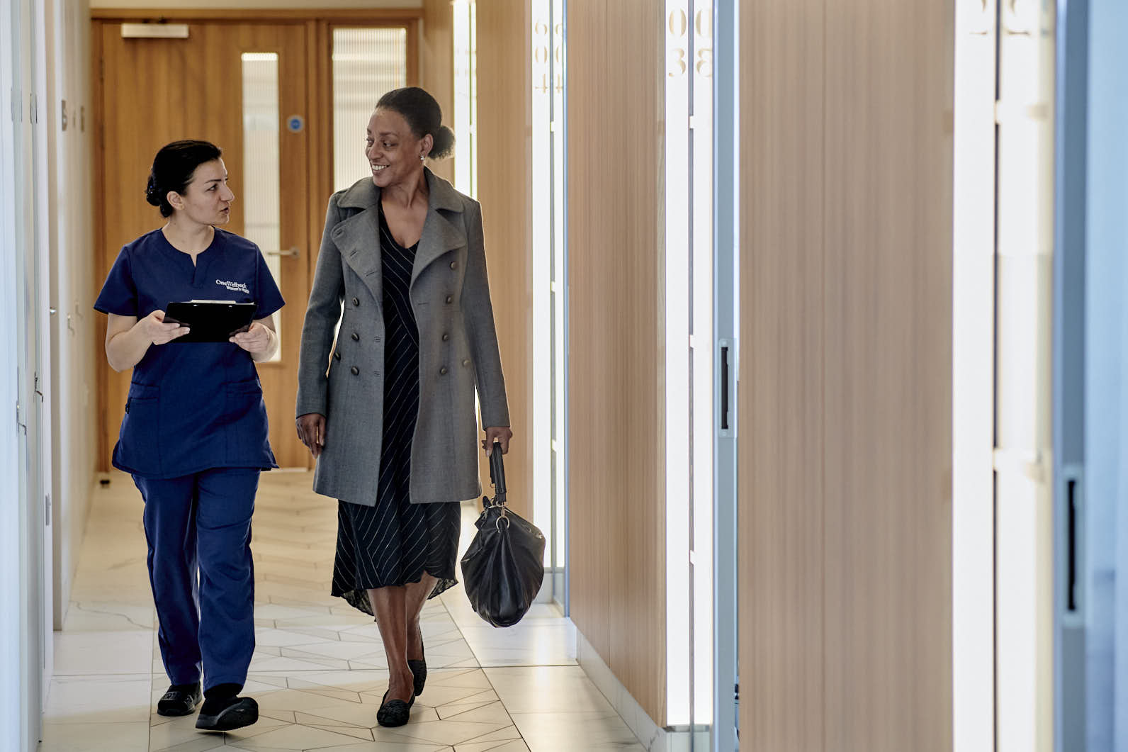 Consultant and patient walking in hallway